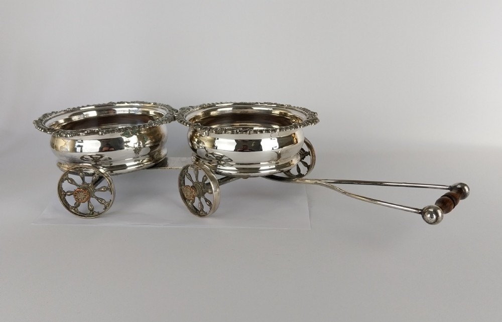 Victorian silver-plated double wine bottle trolley featuring two gadrooned coasters mounted on a wheeled frame with a long handle. View XXIX