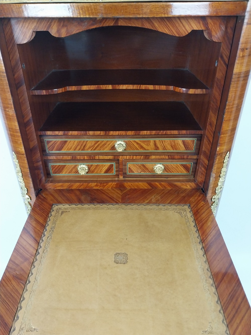 A tall 19th-century French semainier chest of drawers featuring wood marquetry veneer, ornate gilt bronze mounts, seven stacked drawers, and a marble top. View XIV