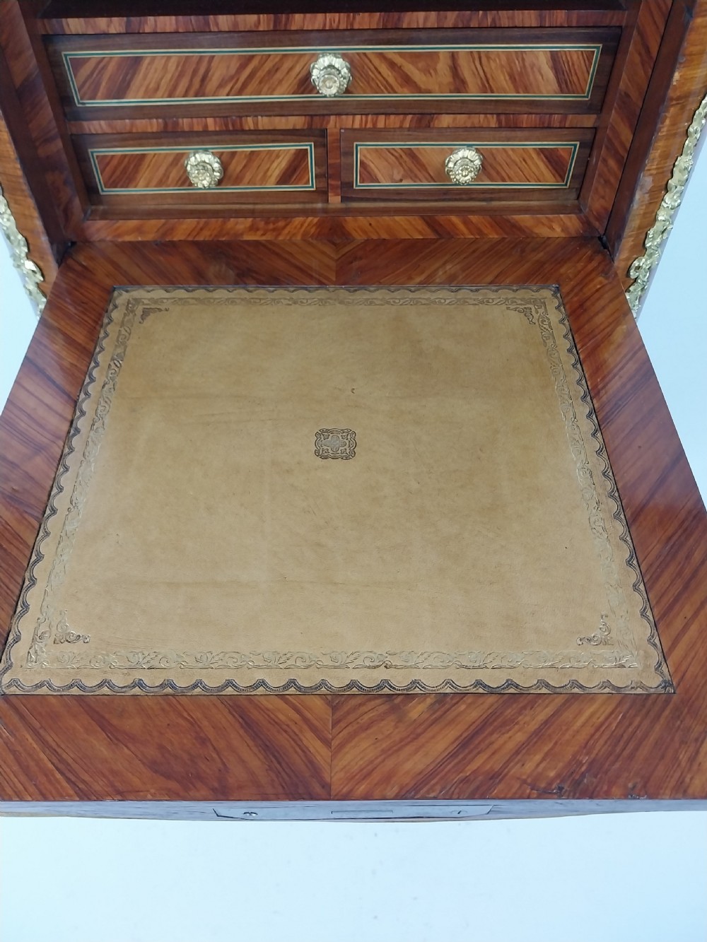 A tall 19th-century French semainier chest of drawers featuring wood marquetry veneer, ornate gilt bronze mounts, seven stacked drawers, and a marble top. View XV