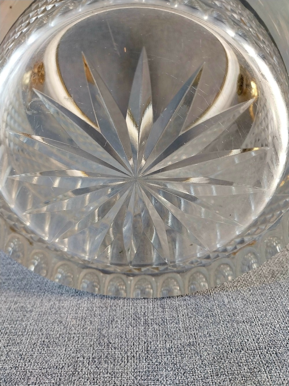 A clear cut glass champagne cooler with etched grapevine detailing, diamond-faceted lower glass, and gilt bronze lion-head ring handles. View XIX