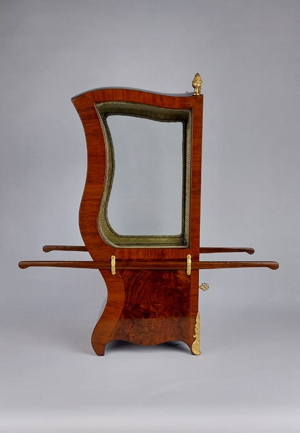A French tabletop sedan chair vitrine cabinet crafted from polished brown wood veneer with gilt-bronze mounts, glazed side panels, removable carrying poles, and a silk damask interior. View III