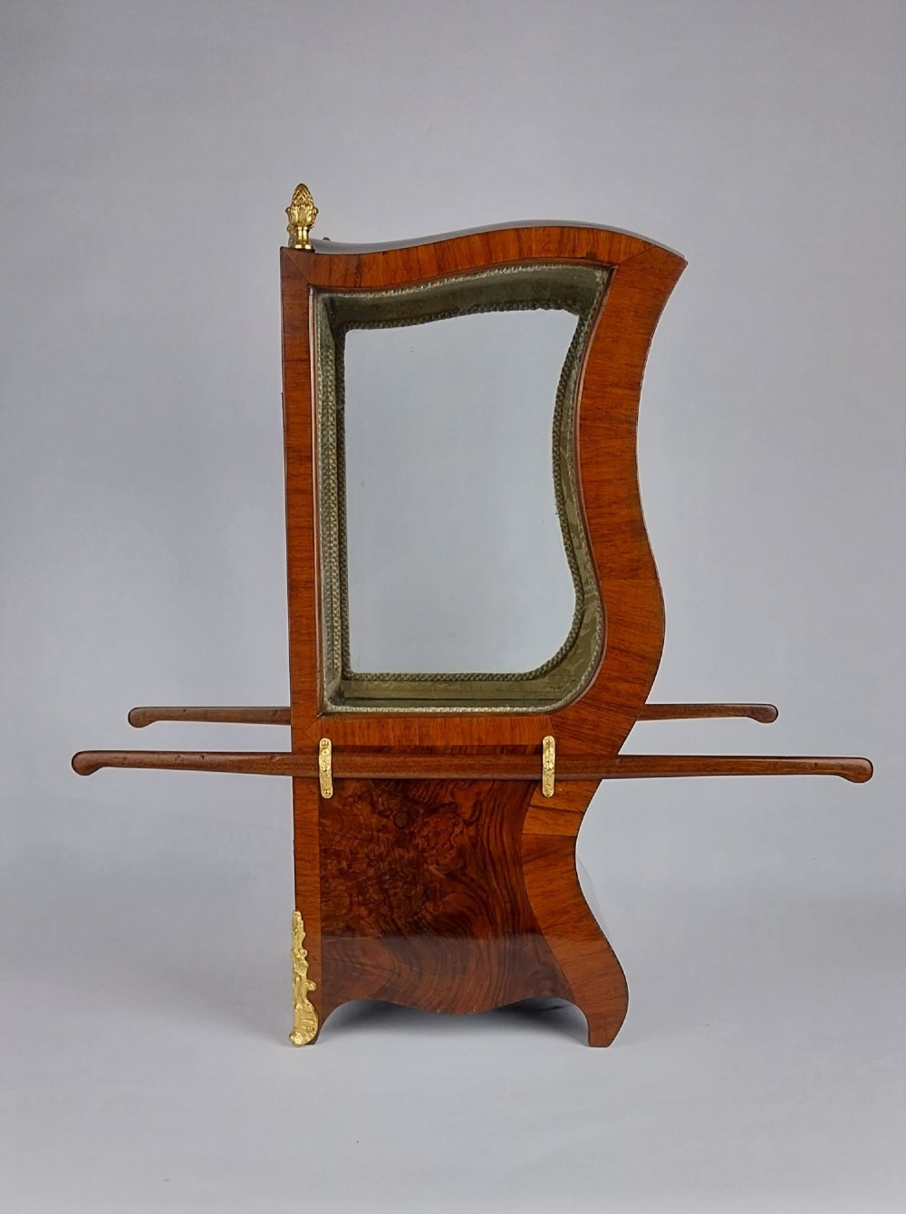 A French tabletop sedan chair vitrine cabinet crafted from polished brown wood veneer with gilt-bronze mounts, glazed side panels, removable carrying poles, and a silk damask interior. View VI