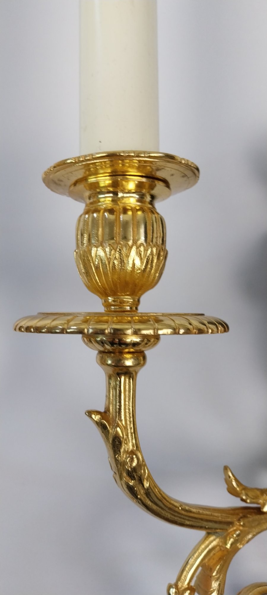 A pair of French gilt and dark patinated bronze two-branch wall sconces featuring central figures holding musical instruments. View IX