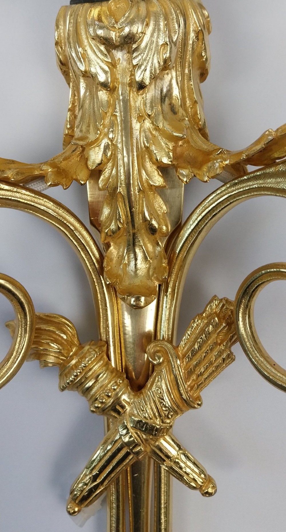 A pair of French gilt and dark patinated bronze two-branch wall sconces featuring central figures holding musical instruments. View XII