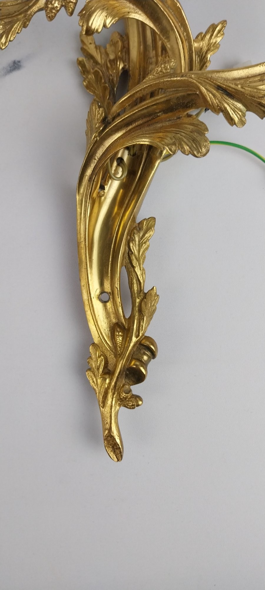 A pair of French Rococo style gilt bronze two-arm wall sconces featuring scrolling acanthus leaf backplates and candle-style sockets. View VIII