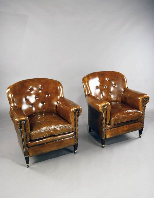A Pair of Antique Leather Shaped Armchairs
