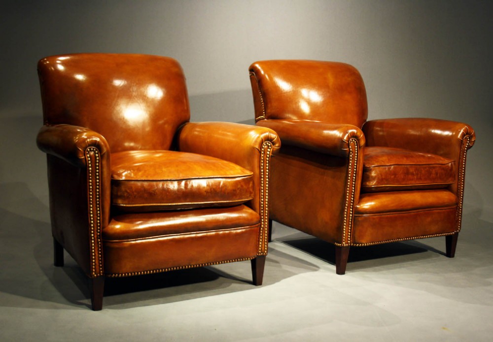 A Pair of Leather Armchairs on Tapering Feet