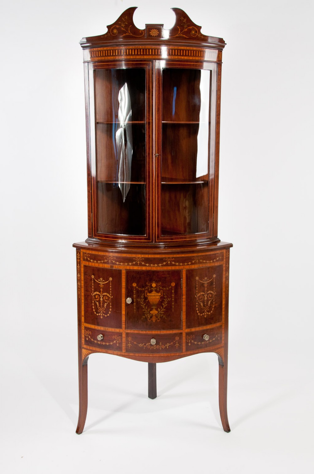 A Very Fine Bow Fronted Inlaid Corner Cabinet