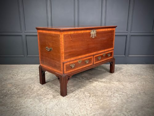 fig 1. A Georgian inlaid mahogany silver chest on stand featuring satinwood crossbanding, brass side carrying handles, two lower drawers, and square legs with bracket corner supports.