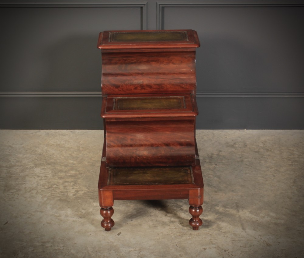 A three-tier Victorian mahogany library step unit featuring leather-lined treads and turned wooden feet. View II