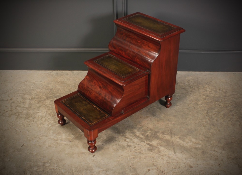 A three-tier Victorian mahogany library step unit featuring leather-lined treads and turned wooden feet. View V