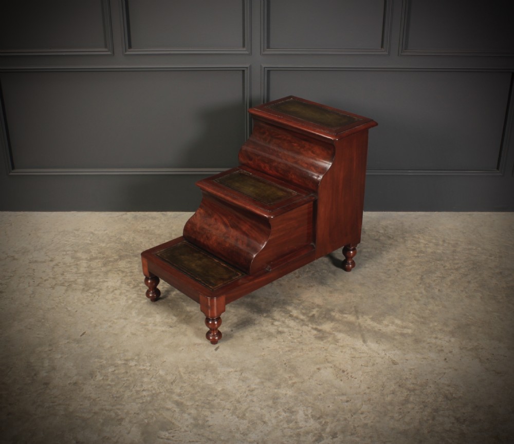 A three-tier Victorian mahogany library step unit featuring leather-lined treads and turned wooden feet. View VI