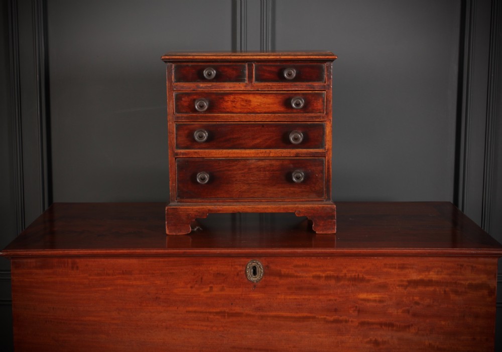 A Georgian style miniature mahogany chest of drawers with two short drawers over three long graduated drawers, turned knobs, and bracket feet. View III