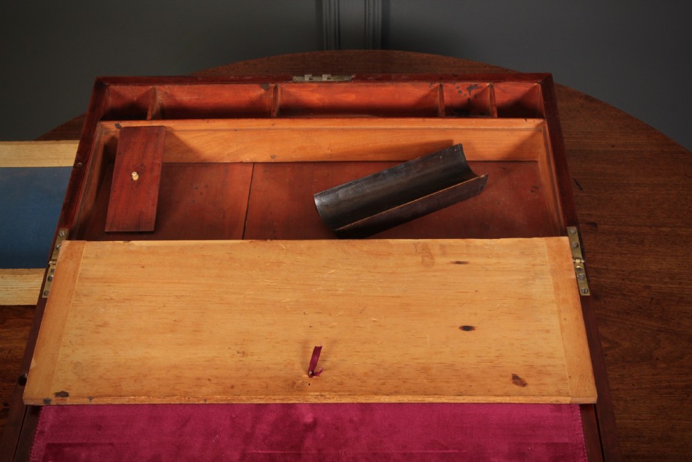 A closed rectangular Victorian mahogany writing slope with brass corner mounts and side carrying handles on a polished wooden surface. View XI