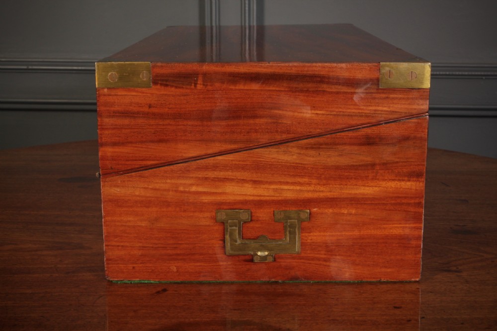 A closed rectangular Victorian mahogany writing slope with brass corner mounts and side carrying handles on a polished wooden surface. View XIII