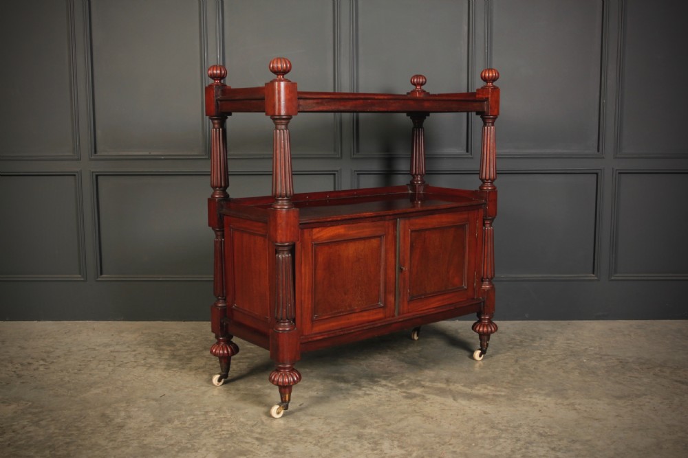 A Victorian mahogany two-tier buffet cabinet featuring turned reeded columns, a lower panelled cupboard, finials, and white castors. View II