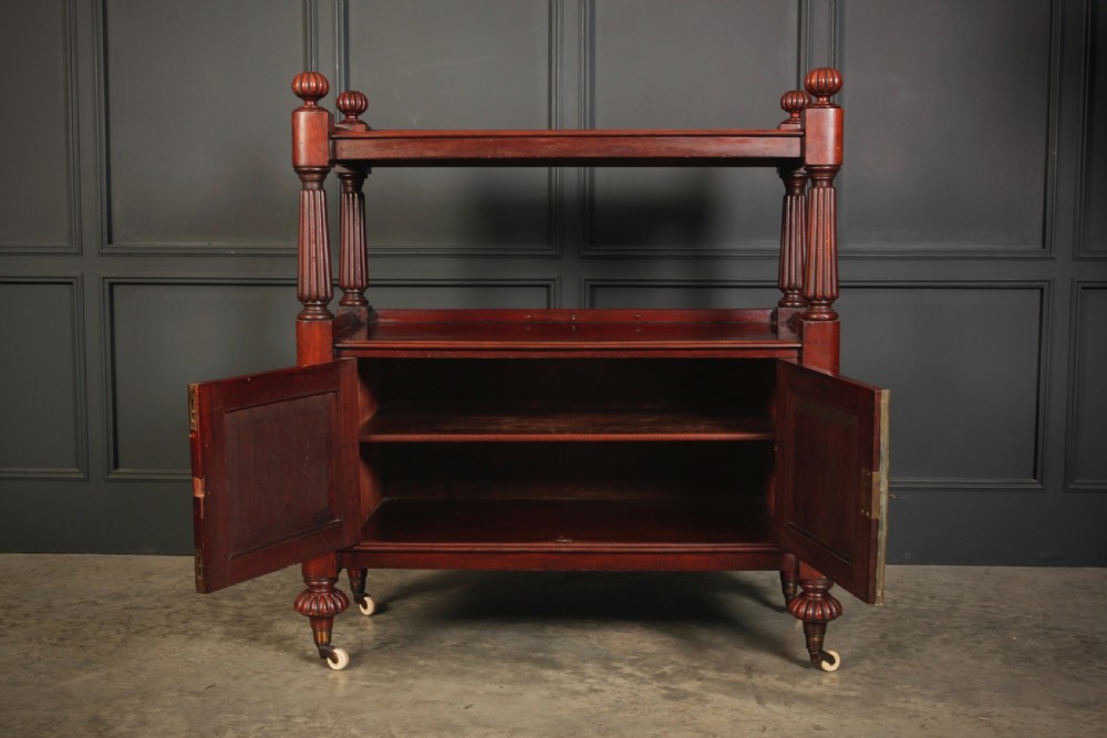 A Victorian mahogany two-tier buffet cabinet featuring turned reeded columns, a lower panelled cupboard, finials, and white castors. View V