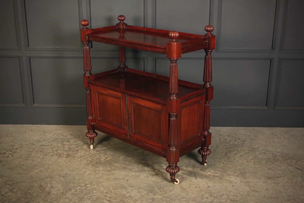 A Victorian mahogany two-tier buffet cabinet featuring turned reeded columns, a lower panelled cupboard, finials, and white castors. View VIII