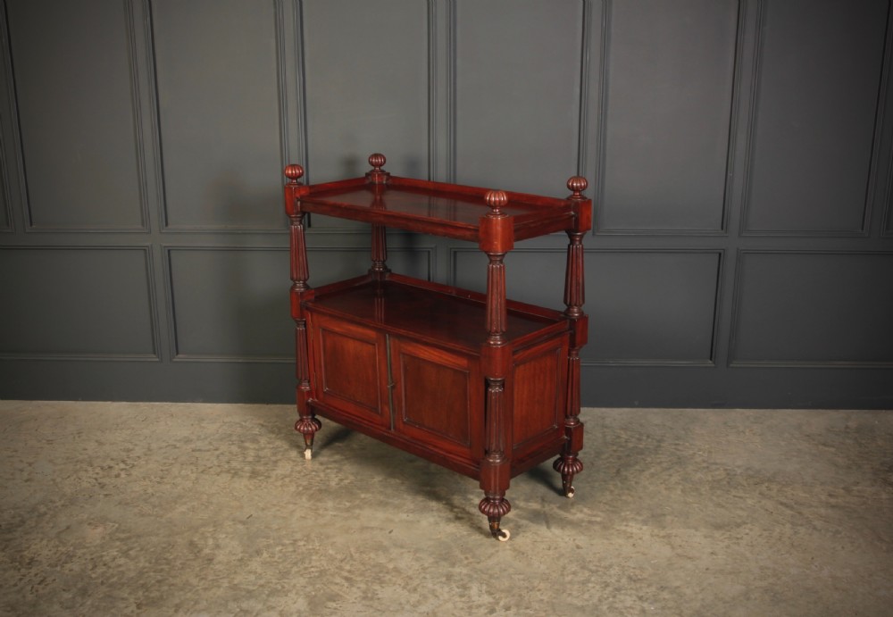 A Victorian mahogany two-tier buffet cabinet featuring turned reeded columns, a lower panelled cupboard, finials, and white castors. View IX