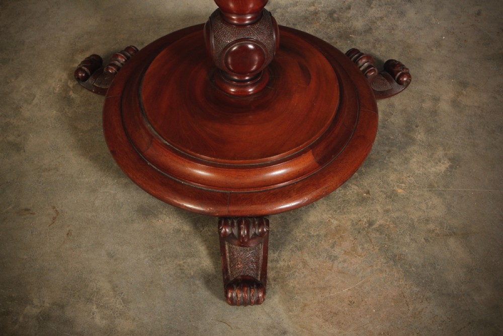 A freestanding Victorian mahogany boot rack with turned upper pegs, a notched central platform, and a turned stem resting on a moulded circular base with carved feet. View III