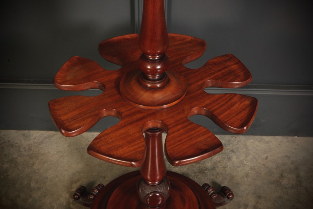 A freestanding Victorian mahogany boot rack with turned upper pegs, a notched central platform, and a turned stem resting on a moulded circular base with carved feet. View IV
