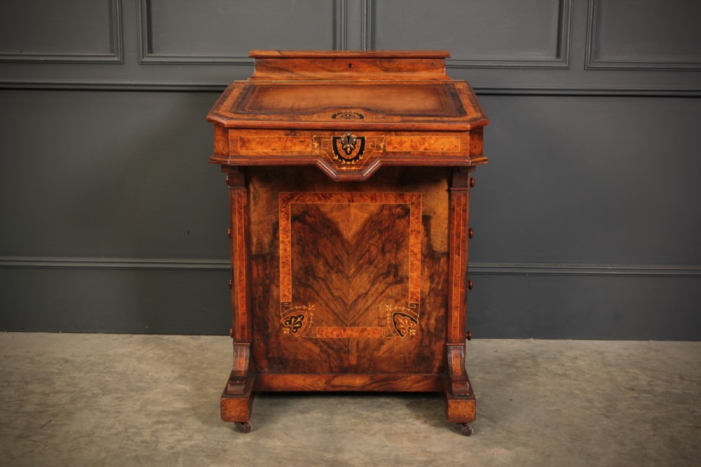 A Victorian figured walnut Davenport desk featuring a sloped leather writing top, intricate marquetry inlays, and a side bank of four drawers with turned wooden handles. View III