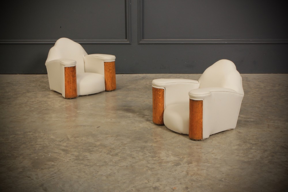 A miniature Art Deco three-piece suite featuring a small sofa and two matching armchairs upholstered in cream leather with polished curved wood arm fronts. View XI