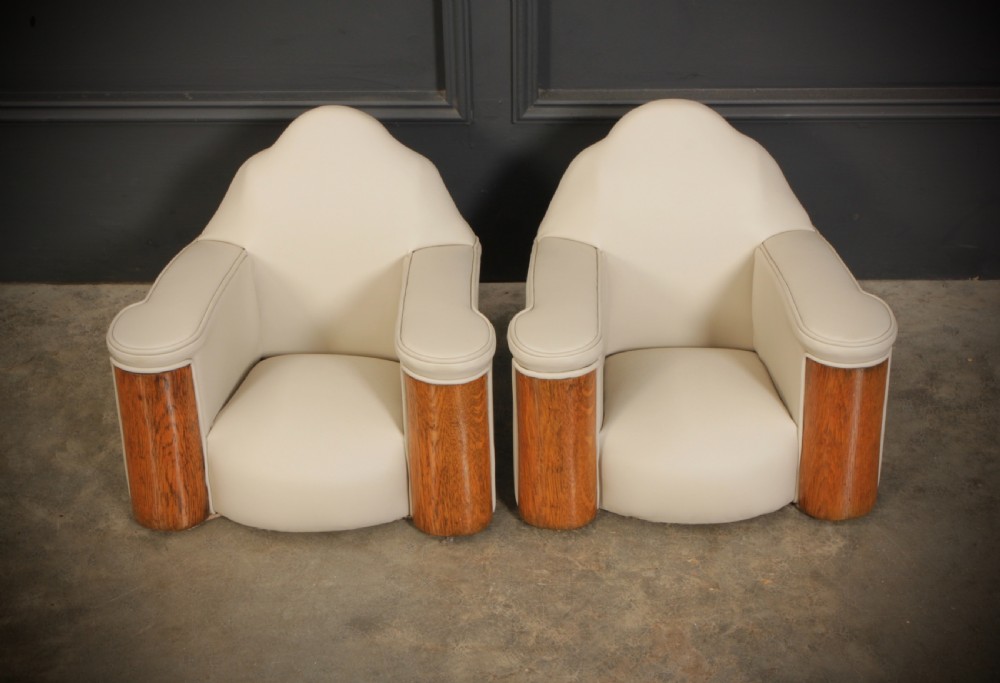 A miniature Art Deco three-piece suite featuring a small sofa and two matching armchairs upholstered in cream leather with polished curved wood arm fronts. View XII