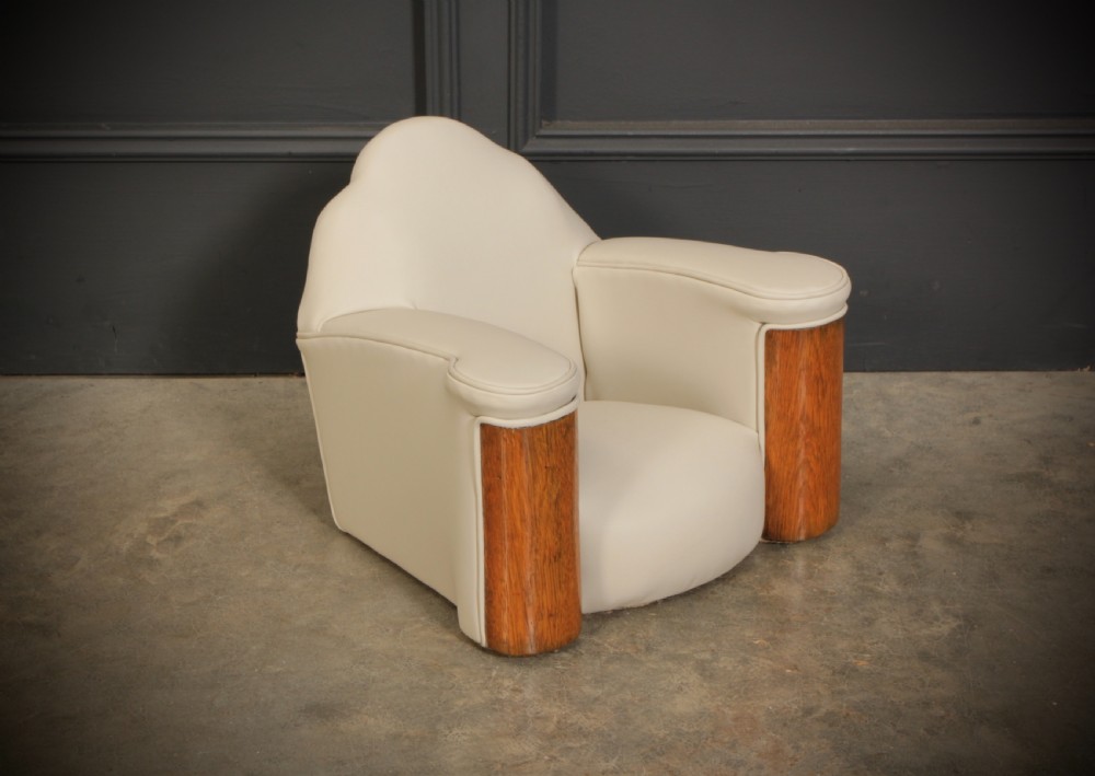 A miniature Art Deco three-piece suite featuring a small sofa and two matching armchairs upholstered in cream leather with polished curved wood arm fronts. View XIV