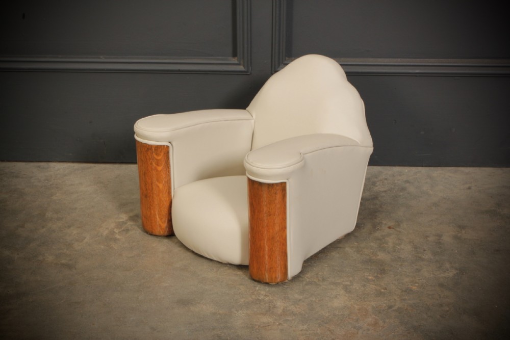 A miniature Art Deco three-piece suite featuring a small sofa and two matching armchairs upholstered in cream leather with polished curved wood arm fronts. View XVI