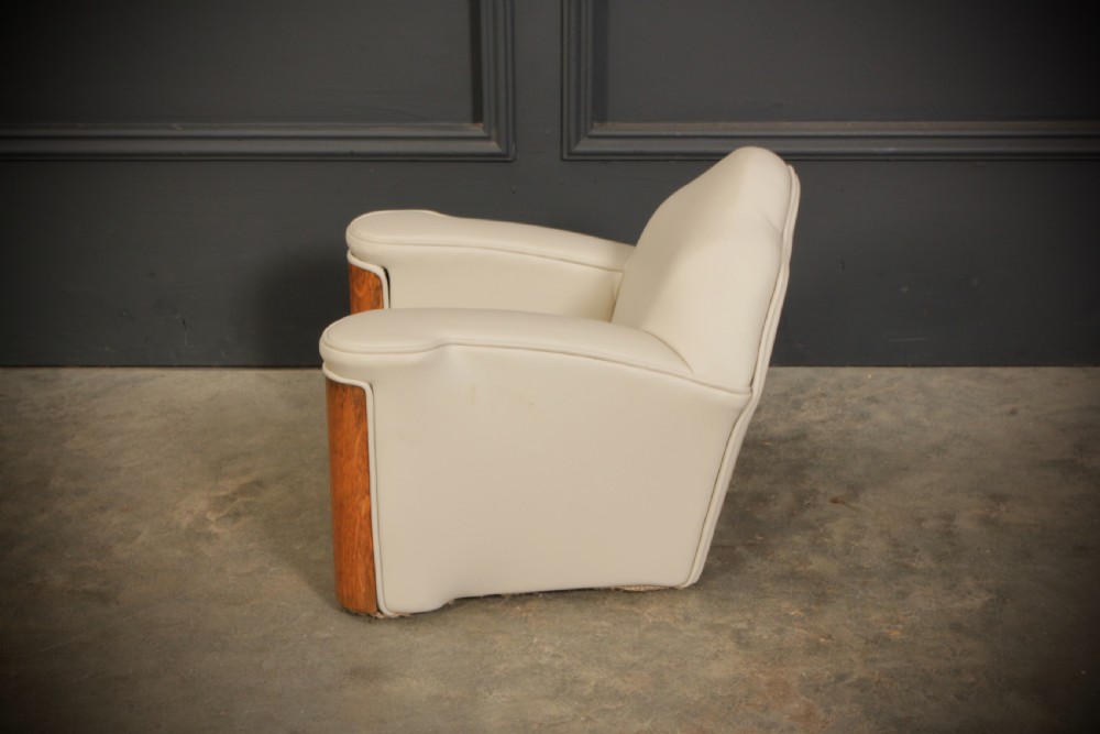 A miniature Art Deco three-piece suite featuring a small sofa and two matching armchairs upholstered in cream leather with polished curved wood arm fronts. View XVII