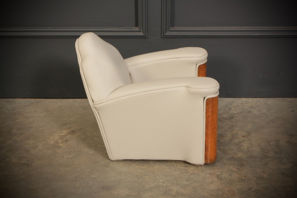 A miniature Art Deco three-piece suite featuring a small sofa and two matching armchairs upholstered in cream leather with polished curved wood arm fronts. View XIX