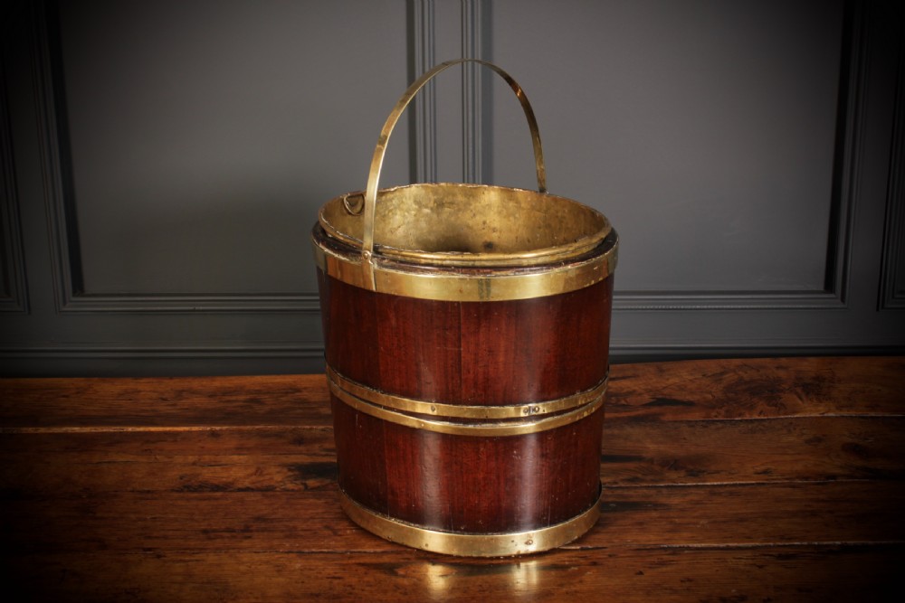 A Georgian staved mahogany peat bucket bound with polished brass hoops and fitted with a brass liner. View IV