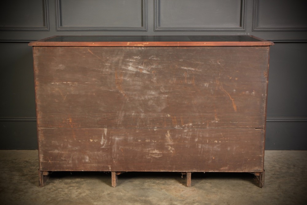 An Early Victorian mahogany kneehole desk with a dark leather writing surface, three frieze drawers, side cupboards, and turned wooden handles. View XI