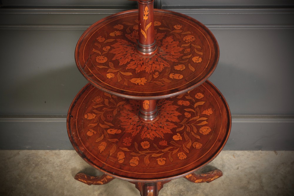 An 18th-century walnut three-tier dumb waiter featuring intricate floral marquetry inlay across three circular trays and a tripod base. View VII
