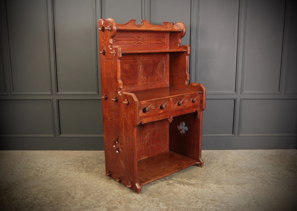A nineteenth-century Gothic Revival elm dresser featuring an open shelf rack above two drawers and an open lower compartment with side quatrefoil cut-outs. View VIII