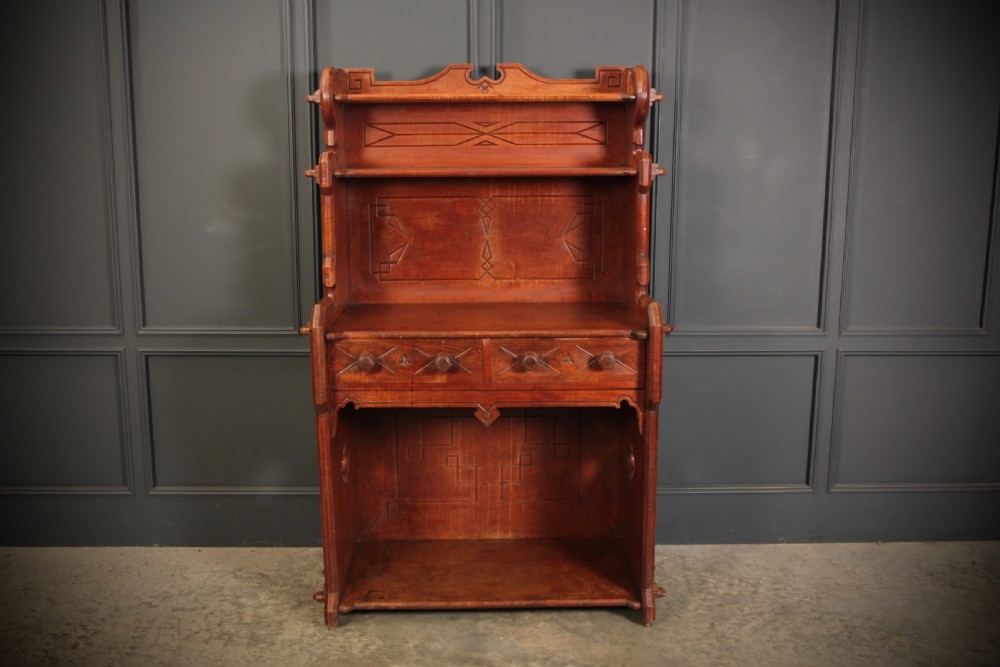 A nineteenth-century Gothic Revival elm dresser featuring an open shelf rack above two drawers and an open lower compartment with side quatrefoil cut-outs. View III