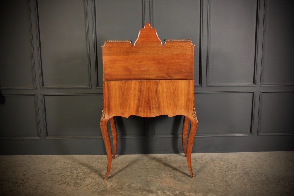 A Victorian burr walnut bonheur du jour writing desk featuring intricate floral marquetry, cabriole legs, brass mounts, and a raised superstructure with small glass cabinets. View XVII