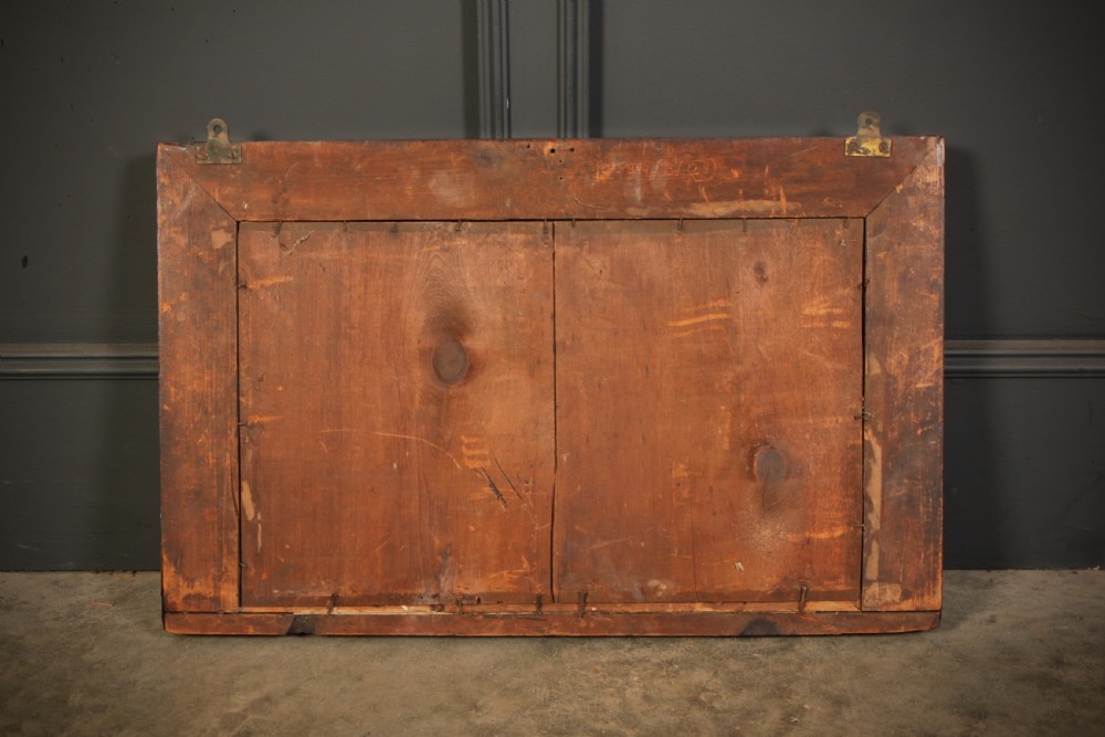 A rectangular antique rosewood overmantel mirror featuring classical side columns with gilt capitals and foxed mirror glass. View II