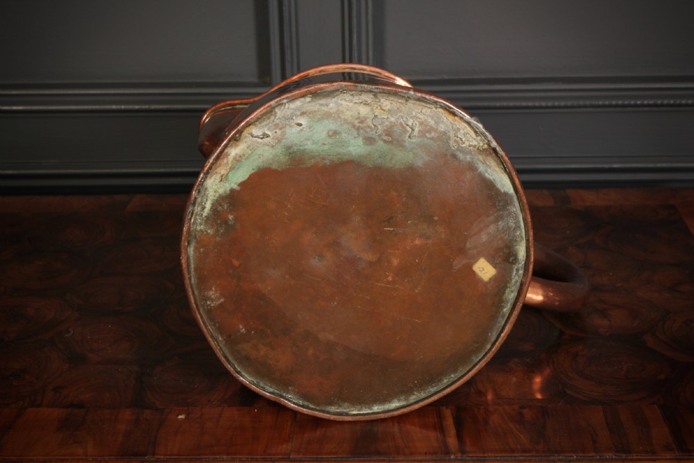 A large polished antique copper jug featuring a sturdy hollow handle, tapered body, and integrated pouring spout. View VI