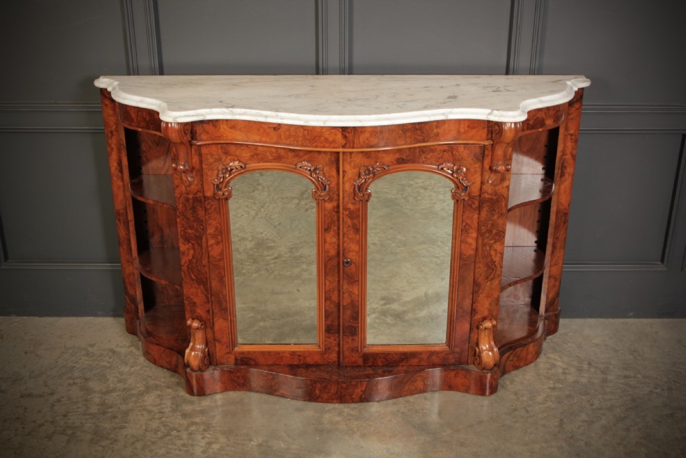 A Victorian burr walnut side cabinet featuring a white marble top, curved side shelves, and mirrored doors flanked by carved corbels. View III