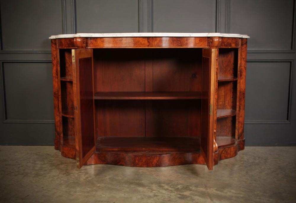 A Victorian burr walnut side cabinet featuring a white marble top, curved side shelves, and mirrored doors flanked by carved corbels. View VIII