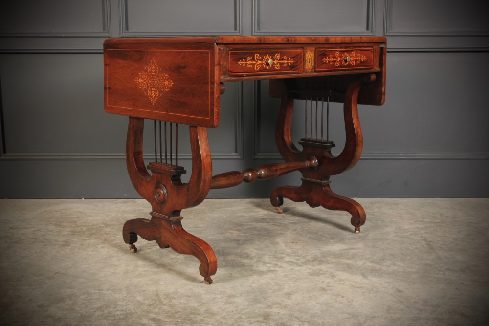 An antique dark brown rosewood sofa table featuring floral marquetry inlay, two drop leaves, twin drawers, and lyre trestle supports. View III