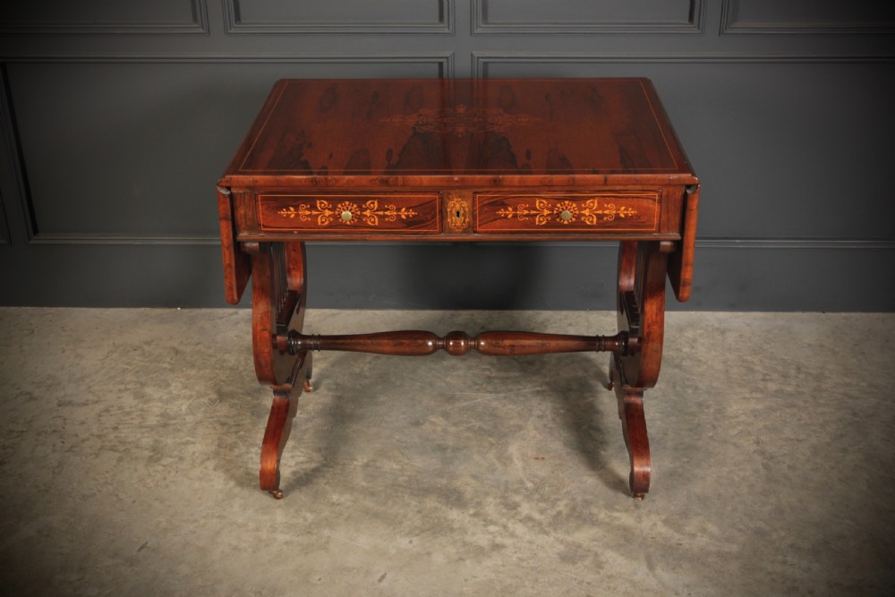 An antique dark brown rosewood sofa table featuring floral marquetry inlay, two drop leaves, twin drawers, and lyre trestle supports. View V