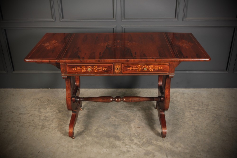 An antique dark brown rosewood sofa table featuring floral marquetry inlay, two drop leaves, twin drawers, and lyre trestle supports. View VI