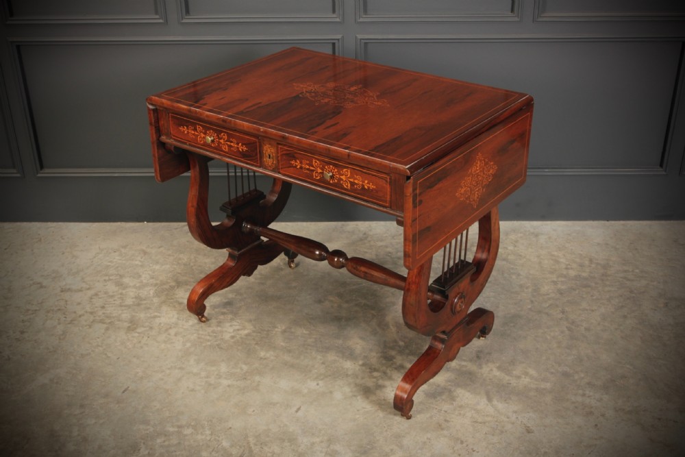 An antique dark brown rosewood sofa table featuring floral marquetry inlay, two drop leaves, twin drawers, and lyre trestle supports. View XI