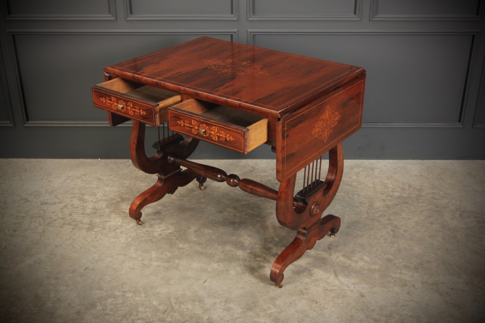An antique dark brown rosewood sofa table featuring floral marquetry inlay, two drop leaves, twin drawers, and lyre trestle supports. View XII