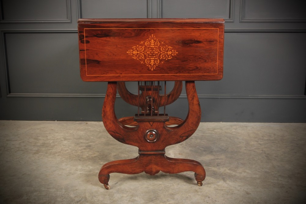 An antique dark brown rosewood sofa table featuring floral marquetry inlay, two drop leaves, twin drawers, and lyre trestle supports. View XIII