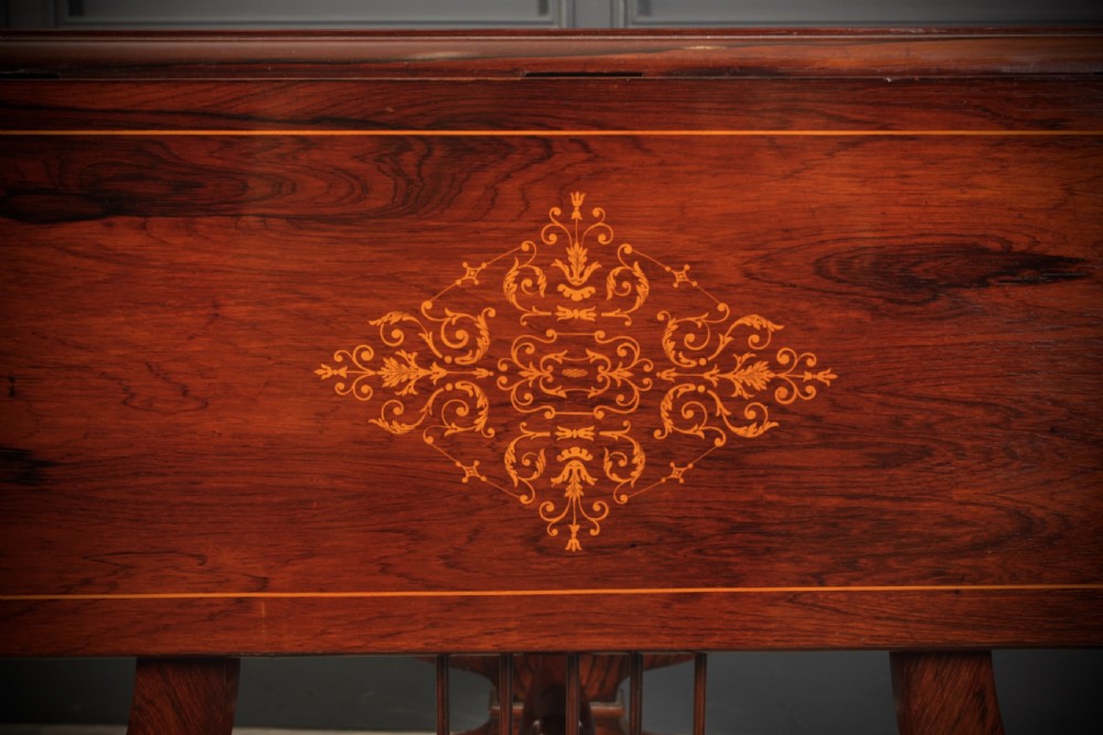 An antique dark brown rosewood sofa table featuring floral marquetry inlay, two drop leaves, twin drawers, and lyre trestle supports. View XIV