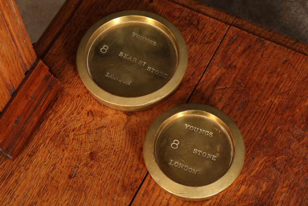 Victorian floor-standing personal weighing scales crafted from oak with brass fittings, balance arm, pan, stacked weights, and a wooden base platform. View XIV